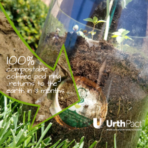 compostable coffee ring in a clear bucket of dirt.